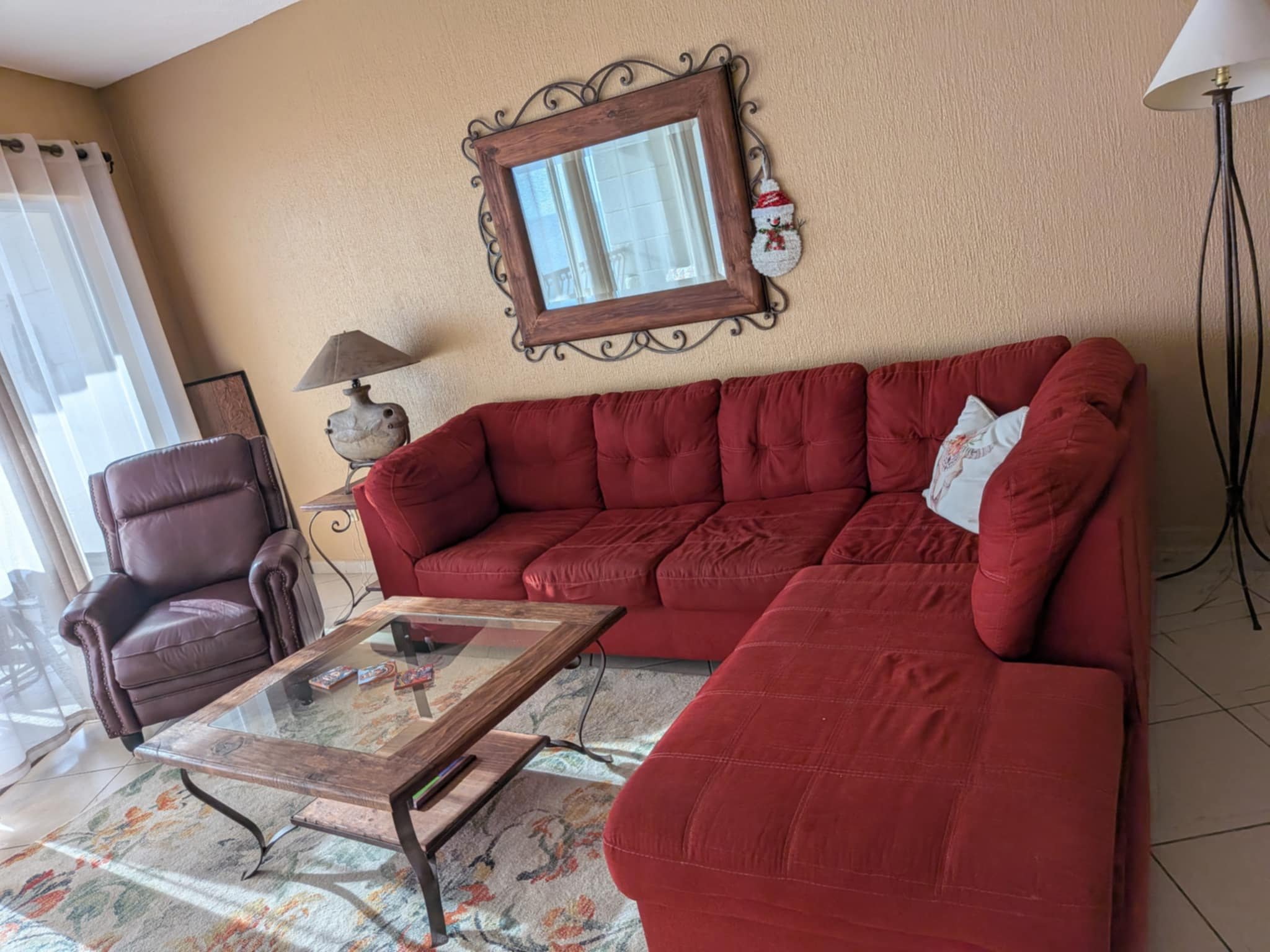 Living room with a large red sectional sofa, recliner and coffee table